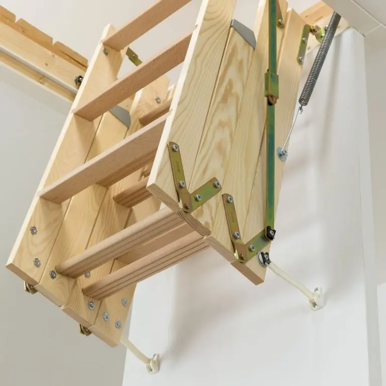 A triple wooden loft ladder folded into its hatch