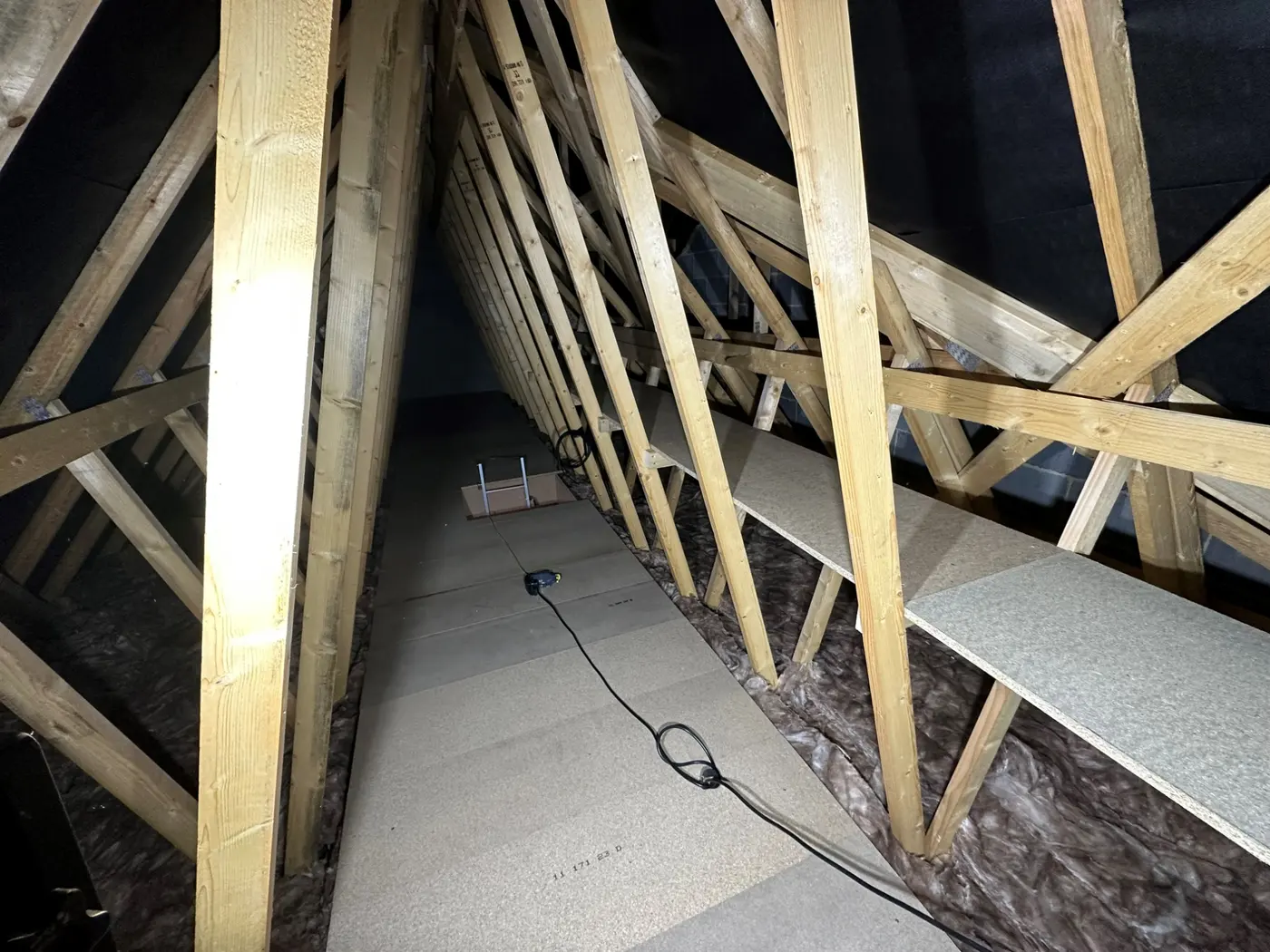 Loft boarding with shelving fitted along the roof slope