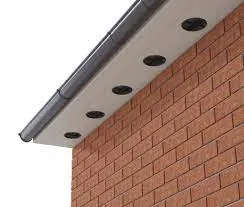 Round soffit vents set into a white soffit board