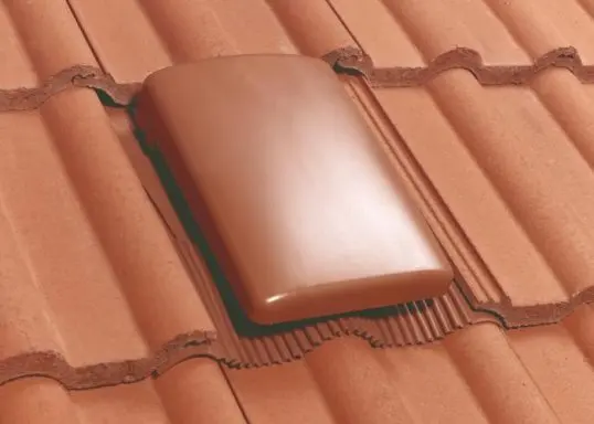 A tile vent in a clay roof