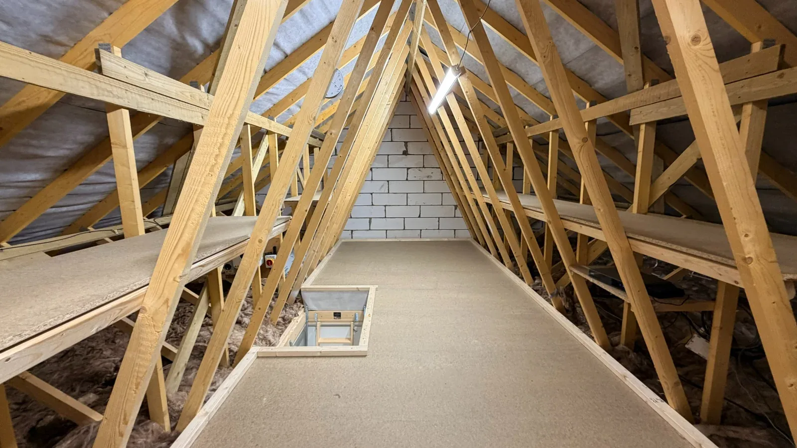 raised loft floor with truss shelving and loft lighting